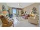Inviting living room with tile floors, a ceiling fan, and access to the balcony at 7 Island Park Pl # 204, Dunedin, FL 34698
