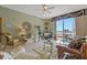 Inviting living room with a ceiling fan, comfortable seating, and sliding doors leading to the balcony at 7 Island Park Pl # 204, Dunedin, FL 34698