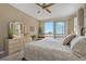 Bright primary bedroom with balcony access and beautiful views from the sliding glass door at 7 Island Park Pl # 204, Dunedin, FL 34698