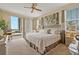 Bright primary bedroom with balcony access and beautiful views from the sliding glass door at 7 Island Park Pl # 204, Dunedin, FL 34698