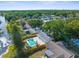 A beautiful backyard featuring a sparkling pool and lush greenery, perfect for relaxation and outdoor enjoyment at 7050 Jenner Ave, New Port Richey, FL 34655