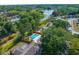 Wide aerial view showing the house, pool, and large wooded lot at 7050 Jenner Ave, New Port Richey, FL 34655
