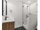 Modern bathroom featuring a glass-enclosed shower, stylish vanity, and contemporary fixtures at 7050 Jenner Ave, New Port Richey, FL 34655