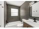 Modern bathroom with tile walls, a shower, and a vanity with a white countertop at 7050 Jenner Ave, New Port Richey, FL 34655