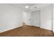 Bright bedroom featuring wood floors, white walls, and a closet with folding doors at 7050 Jenner Ave, New Port Richey, FL 34655