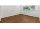 Bright bedroom showcasing wood floors and large windows that let in natural light at 7050 Jenner Ave, New Port Richey, FL 34655