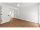 Bright bedroom featuring wood floors, white walls, and a closet with mirrored doors at 7050 Jenner Ave, New Port Richey, FL 34655