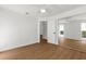 Bright bedroom featuring wood floors, white walls, and a closet with mirrored doors at 7050 Jenner Ave, New Port Richey, FL 34655