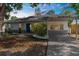 A well kept home with landscaping, stone accents and a walkway at 7050 Jenner Ave, New Port Richey, FL 34655