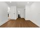 Hallway with updated flooring, doors and hardware leading to a kitchen and bathroom at 7050 Jenner Ave, New Port Richey, FL 34655