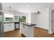 Modern kitchen with stainless steel appliances and island counter, overlooking backyard pool at 7050 Jenner Ave, New Port Richey, FL 34655