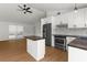 Bright kitchen with stainless appliances, white cabinets, and a stylish island with a butcher block top at 7050 Jenner Ave, New Port Richey, FL 34655