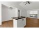 Open kitchen with a dark countertop island and bright white cabinets offers a modern space at 7050 Jenner Ave, New Port Richey, FL 34655