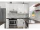 Modern kitchen with stainless steel appliances, stylish countertops, and bright white cabinets at 7050 Jenner Ave, New Port Richey, FL 34655