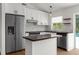 Stylish kitchen featuring white cabinets, stainless steel appliances, and modern countertops at 7050 Jenner Ave, New Port Richey, FL 34655