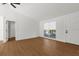Bright and open living room with hardwood floors and large windows, perfect for entertaining at 7050 Jenner Ave, New Port Richey, FL 34655