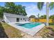 Inviting backyard pool and spa with gray brick surround, perfect for relaxation and entertaining at 7050 Jenner Ave, New Port Richey, FL 34655