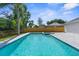 Backyard featuring a pool, a hot tub, and a paved patio at 7050 Jenner Ave, New Port Richey, FL 34655