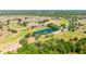 Panoramic aerial view showcasing community amenities like a lake, pool, clubhouse, and golf course amidst lush landscape at 7061 Lamium Ct, Brooksville, FL 34602