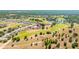Wide aerial shot displaying homes in a community nestled beside a golf course, with trees and green spaces at 7061 Lamium Ct, Brooksville, FL 34602