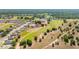 Overhead shot highlighting neighborhood homes adjacent to a golf course, with tree coverage and lush scenery at 7061 Lamium Ct, Brooksville, FL 34602