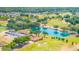 High-angle shot featuring a community lake, clubhouse, and golf course, highlighting the area's recreational opportunities at 7061 Lamium Ct, Brooksville, FL 34602