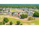 Expansive aerial view of a neighborhood with golf course, showcasing community layout and green spaces at 7061 Lamium Ct, Brooksville, FL 34602