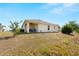 The backyard features a covered patio, lawn, and mature landscaping, with views of the community at 7061 Lamium Ct, Brooksville, FL 34602
