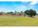 Rear view of the house and backyard that overlooks the expansive community golf course at 7061 Lamium Ct, Brooksville, FL 34602