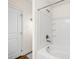 Bright bathroom features a combined tub and shower with a white tiled surround at 7061 Lamium Ct, Brooksville, FL 34602