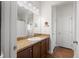 Bathroom features a vanity with a sink, granite countertops and bright vanity lighting at 7061 Lamium Ct, Brooksville, FL 34602