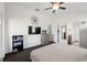 Bright bedroom with neutral decor, large windows, ceiling fan, and ensuite bathroom at 7061 Lamium Ct, Brooksville, FL 34602