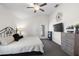 Comfortable bedroom with ceiling fan, gray dresser, and exterior door for convenience at 7061 Lamium Ct, Brooksville, FL 34602