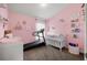 Bedroom featuring a crib, baby-friendly decor, and carpeted floors at 7061 Lamium Ct, Brooksville, FL 34602