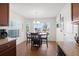 Cozy dining area featuring a chandelier, wood floors, and a view of the outdoors at 7061 Lamium Ct, Brooksville, FL 34602