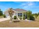 Attractive single-story home with a well-kept lawn, a variety of shrubbery, and an attached two-car garage at 7061 Lamium Ct, Brooksville, FL 34602