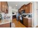 A functional kitchen showcasing stainless steel appliances, wood cabinetry, and ample countertop space at 7061 Lamium Ct, Brooksville, FL 34602