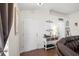 Bright living room with wood flooring, a white door, and a console table with decorative items at 7061 Lamium Ct, Brooksville, FL 34602