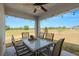 Covered patio featuring a ceiling fan, string lights and views of the backyard and golf course at 7061 Lamium Ct, Brooksville, FL 34602