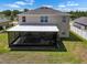 Aerial shot features a large screened patio ideal for outdoor entertaining and relaxation at 718 Tidal Rock Ave, Ruskin, FL 33570