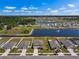 Aerial view of a residential neighborhood with houses situated around a scenic lake with fountain at 718 Tidal Rock Ave, Ruskin, FL 33570