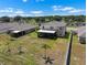 Aerial view showcasing a spacious backyard with a screened lanai and lush landscaping at 718 Tidal Rock Ave, Ruskin, FL 33570