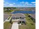 Aerial view of a two-story home near a lake with a fountain, showcasing its prime location at 718 Tidal Rock Ave, Ruskin, FL 33570