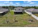 Aerial view showcasing a spacious backyard with a screened lanai and lush landscaping at 718 Tidal Rock Ave, Ruskin, FL 33570