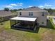 Backyard with screened-in lanai, perfect for outdoor living and entertaining in a fenced yard at 718 Tidal Rock Ave, Ruskin, FL 33570