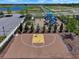 Aerial view of an outdoor basketball court with seating, adding to the recreational amenities for active residents at 718 Tidal Rock Ave, Ruskin, FL 33570