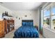Cozy bedroom with a plush bed, Star Wars themed stickers, and a large window at 718 Tidal Rock Ave, Ruskin, FL 33570