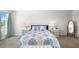 Cozy bedroom showcasing a comfortable bed, matching nightstands, and a full-length mirror at 718 Tidal Rock Ave, Ruskin, FL 33570