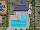 Aerial view of the community pool and clubhouse, with resort-style amenities amidst lush landscaping at 718 Tidal Rock Ave, Ruskin, FL 33570