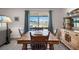 Cozy dining area featuring a wooden table set and a picturesque view of the lake at 718 Tidal Rock Ave, Ruskin, FL 33570